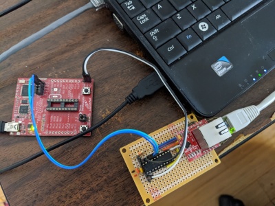 Microchip ENC28J60 board next to MSP430 launchpad debugger.